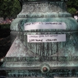 In this photo one can see heavy corrosion crust on the cast bronze surface that presents a serious physical threat. The crust distorts and hides the surface details and texture of the sculpted cast bronze. Removal of the corrosion crust allows a maximum range of replicating the original patination. This photo exhibits the lamp before conservation treatment.