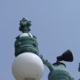 This is a close up view of broken globes & damaged interior electrical system - all electrical systems and globes were up-dated during the conservation treatment.  Numerous missing elements due to vandalism or weather related were re-produced & attached using archival photos from the Smithsonian Institute. This photo exhibits the lamps before conservation treatment.