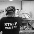 The technician is applying silicon rubber over the entire cast bronze lantern for the first step in the mold making process.