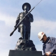 The completed World War I Dough Boy is now free of corrosion and fractures. The saber was fabricated from a bronze sheet due to a vandalized saber. The hot chemical patina was performed in house as well as the hot wax treatment. Our technician is performing the final cleanup after the installation.