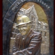 Sculpted lost wax cast portrait plaque in memory of George Rakoczy with hot chemical patina and polished letters